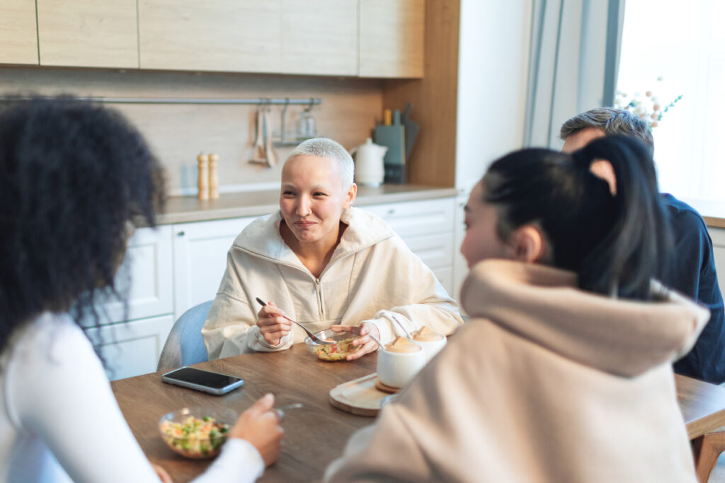 Photograph of friends enjoying a meal together at a dining table